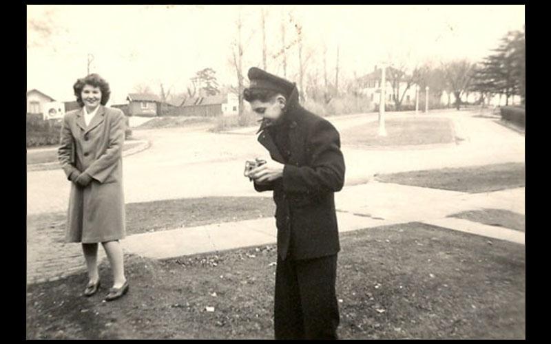 Jean and Northwest's Navy V-12 Program | Northwest 1945 graduate and computing pioneer, Jean Jennings Bartik, stands outside her Maryville residence on 4th Street chatting with one of the men in the Navy V-12 program.(Courtesy of Jean JENNINGS Bartik Computing Museum)